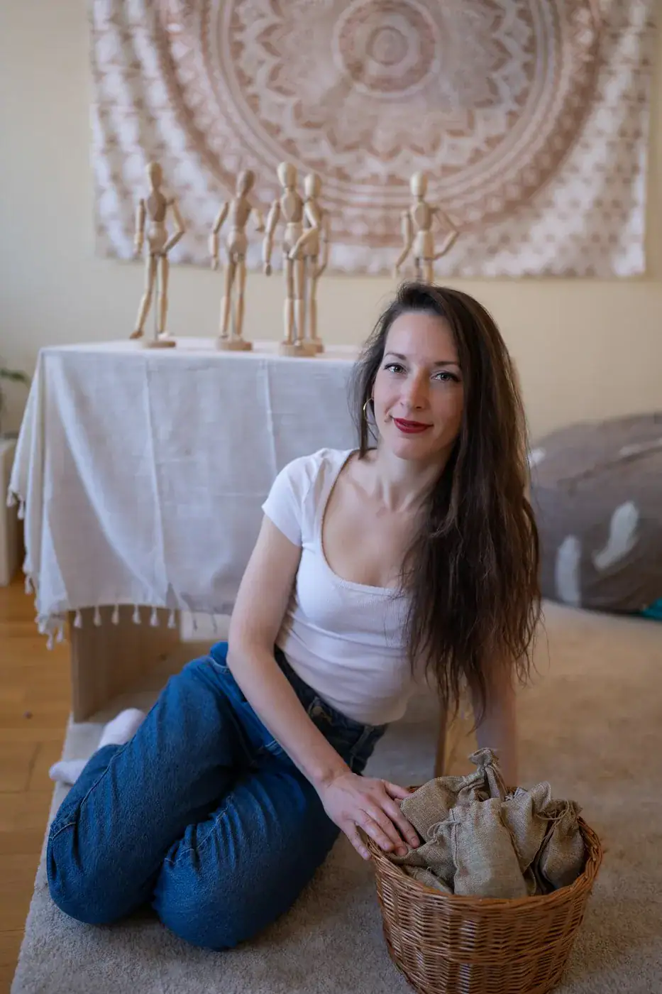 Szekeres Gabriella családállító fa figurákkal a padlón